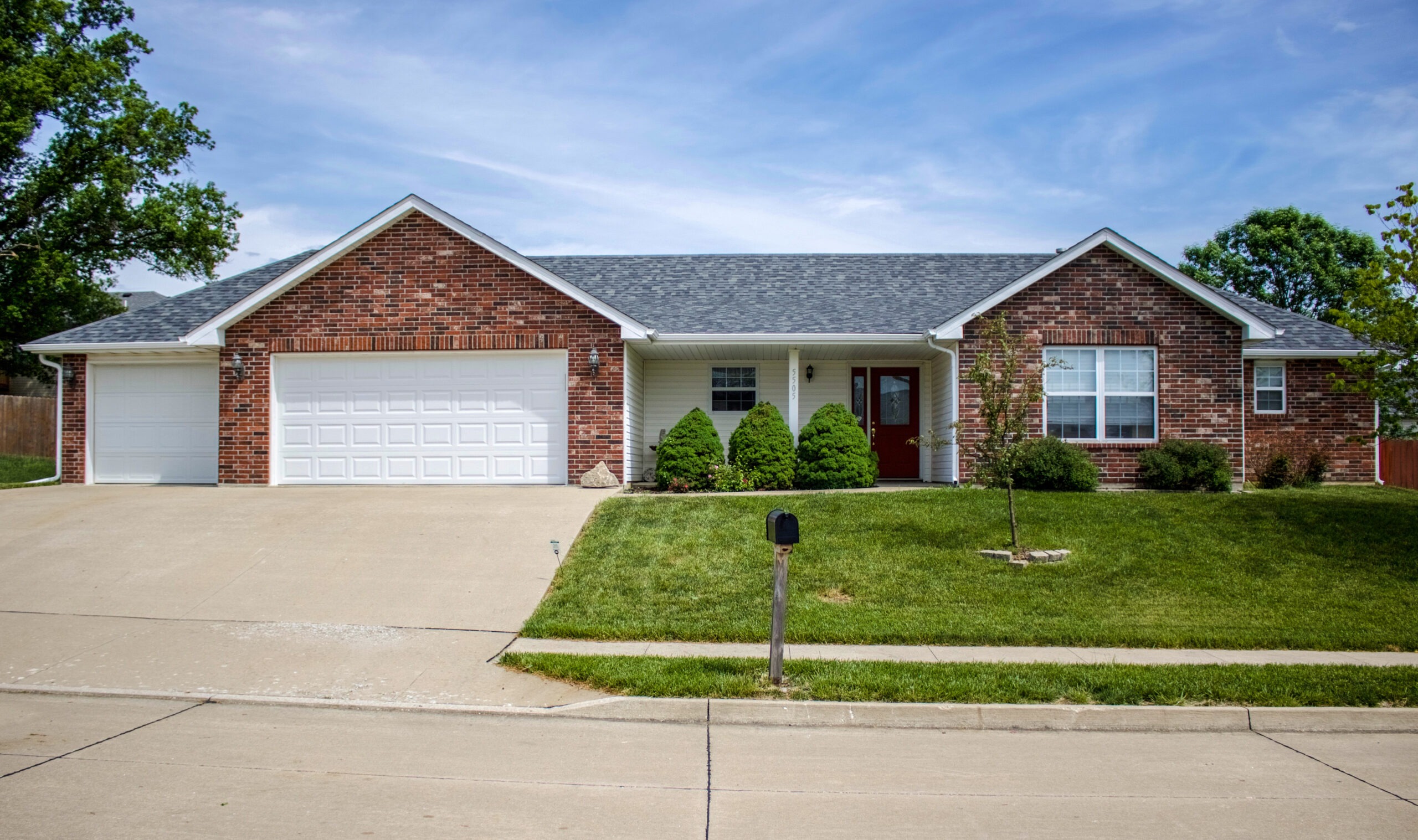 Brick house with new grey shingle roofing