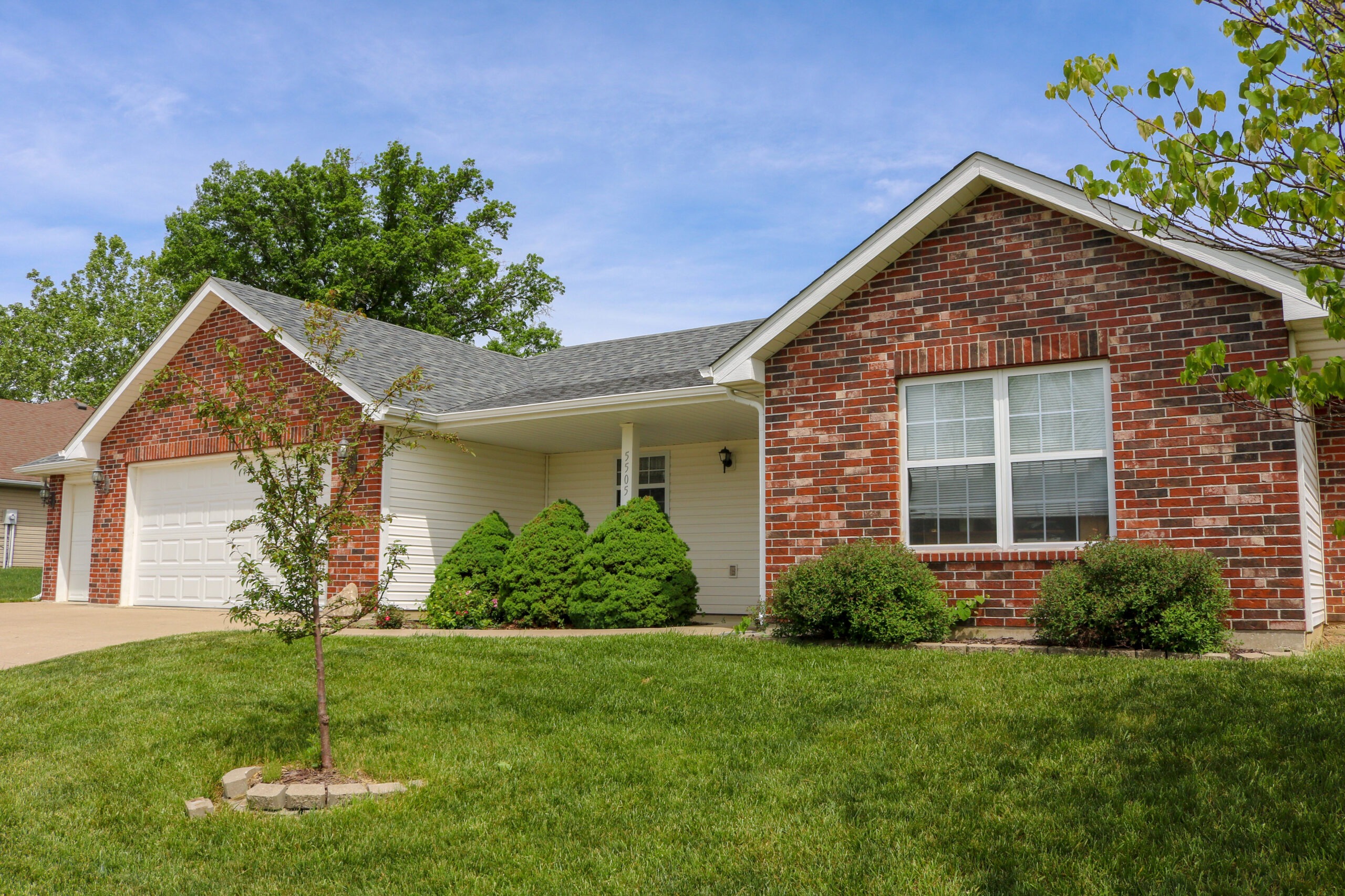 Traditional Brick home in Columbia Missouri with new grey roof.