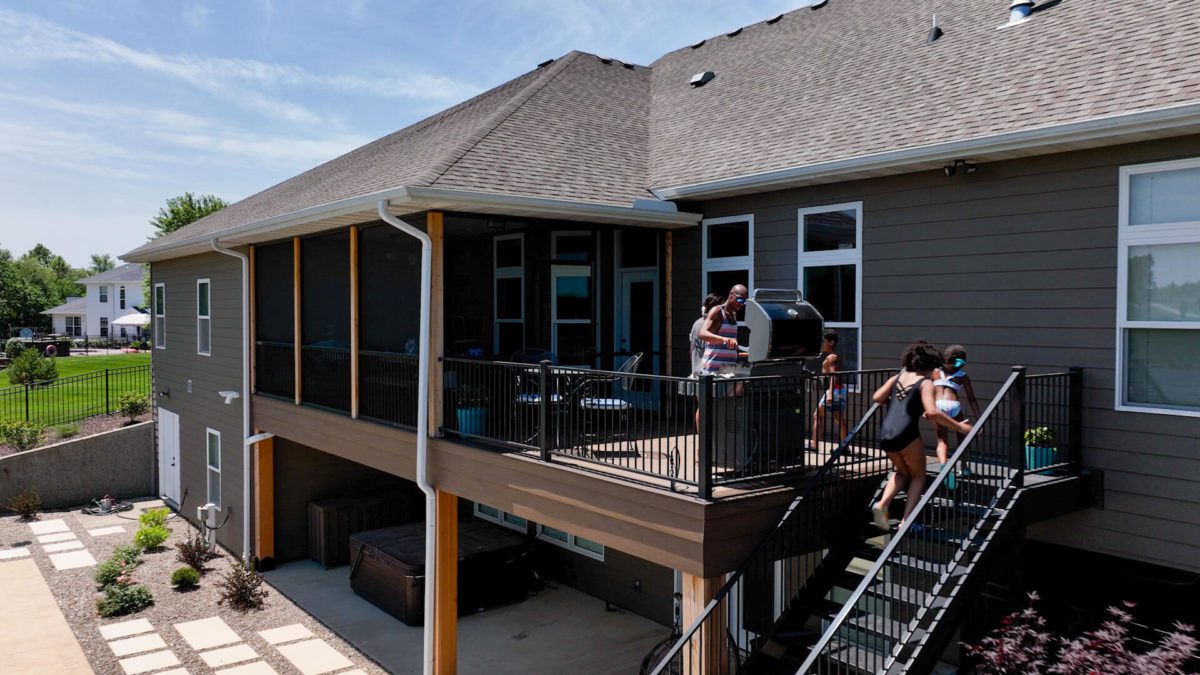 Metal deck railing, brown shingle roof