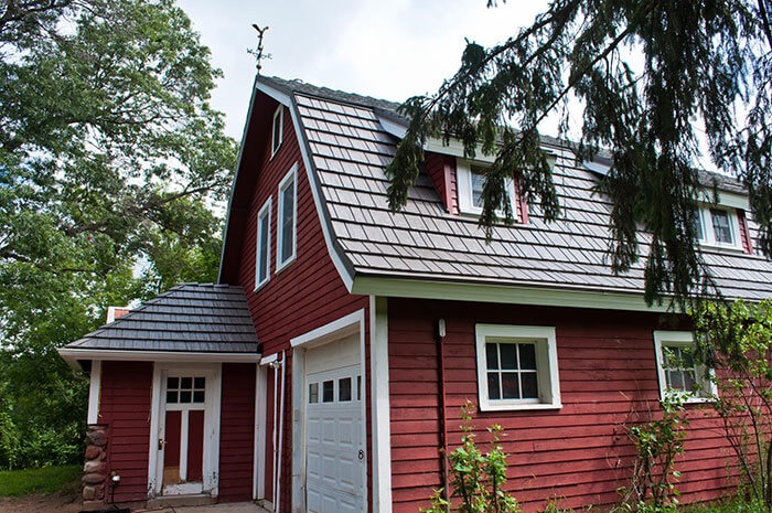 red farm house with new shingled roof