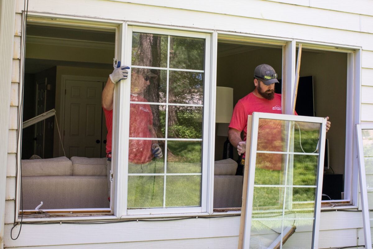 two men installing new windows to increase a home's value