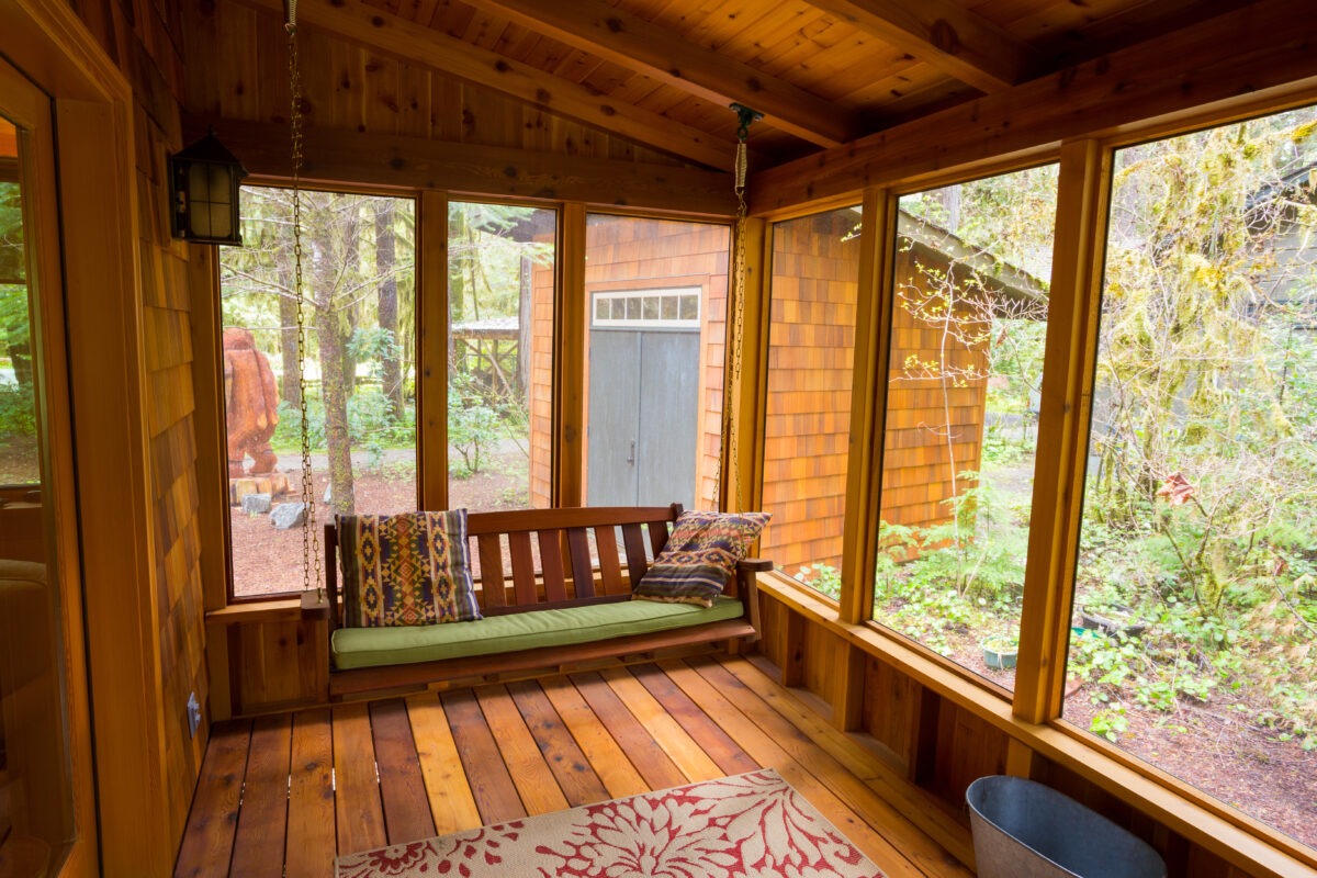 Bench swing hung by chain looking comfortable on a 12x12 sunroom