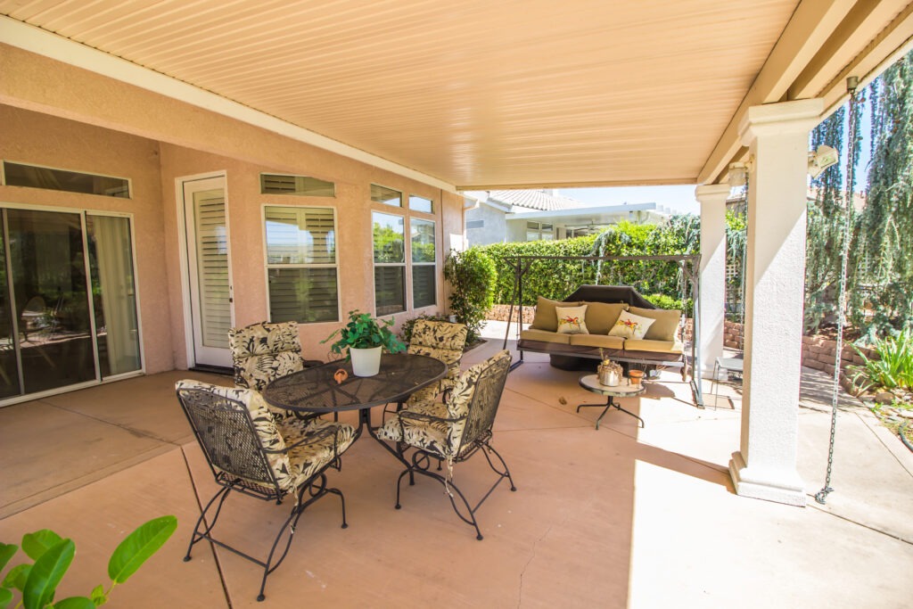 modern rear covered patio attached to house with chairs and table