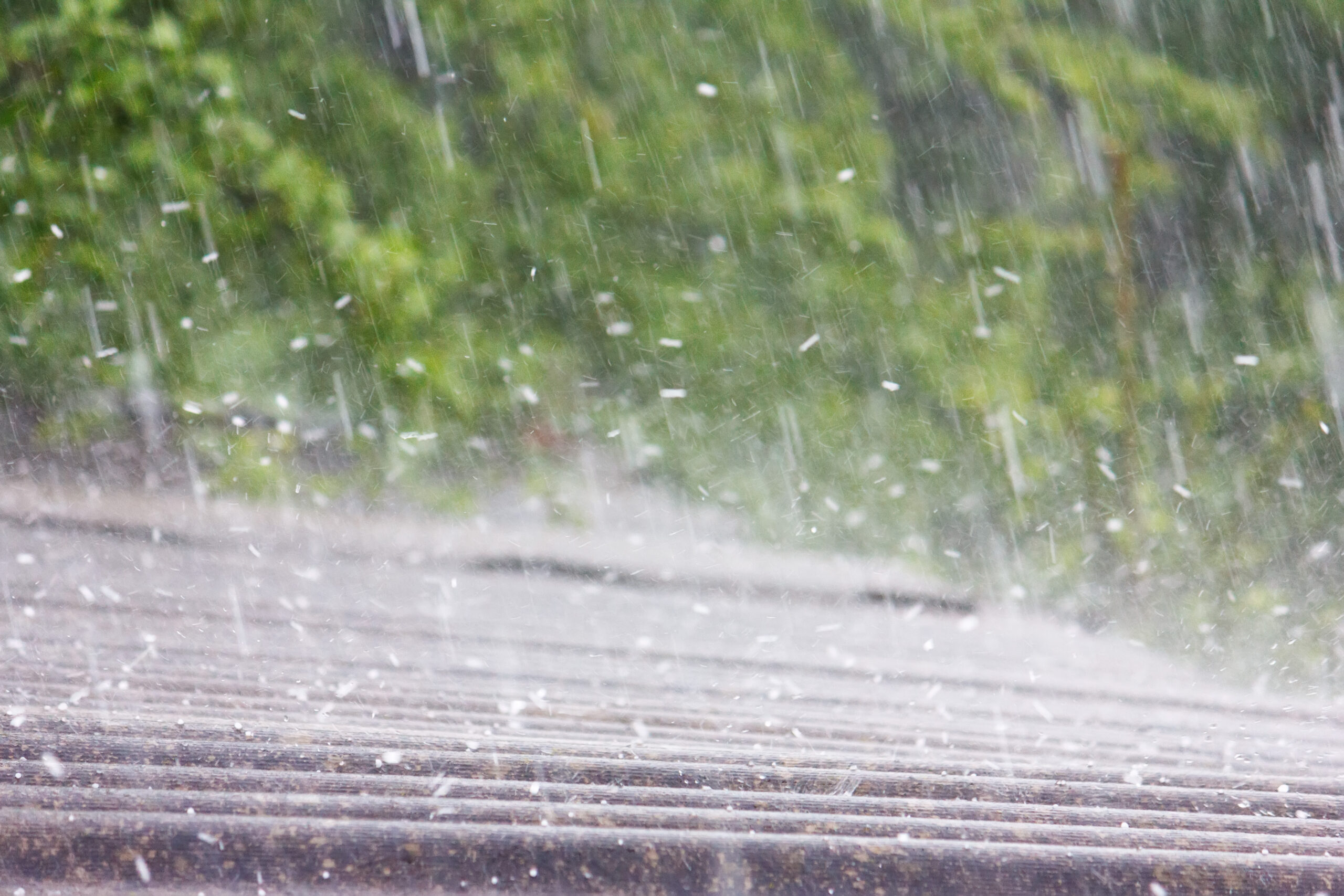 hail falling onto a residential roof in the summer time